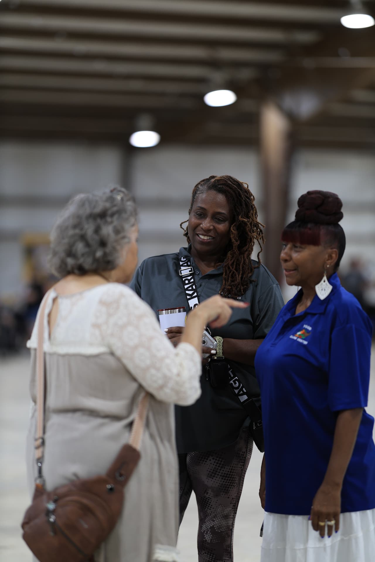 Community volunteers talking together inside the venue.