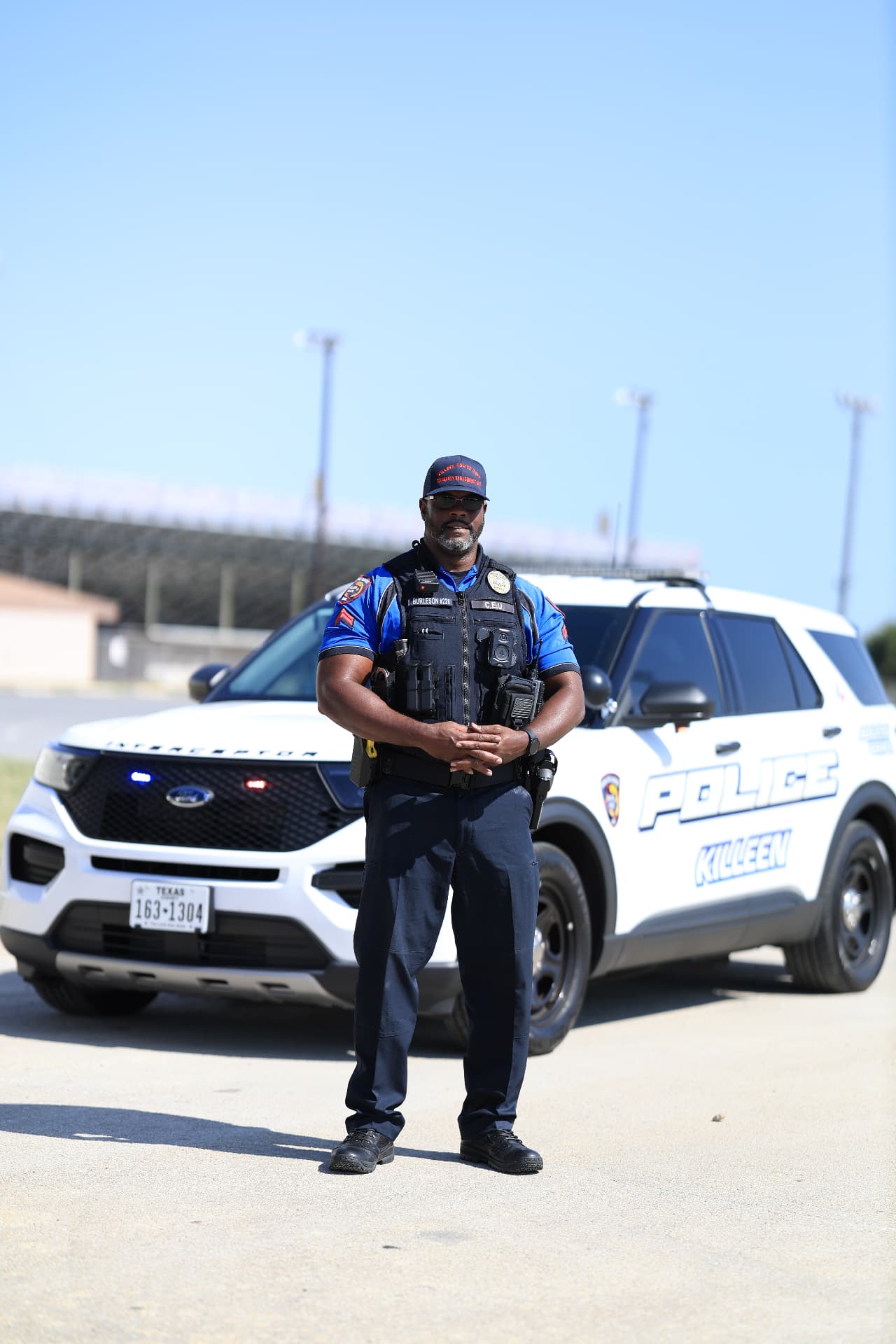 A Killeen Police officer standing in front of his patrol vehicle.