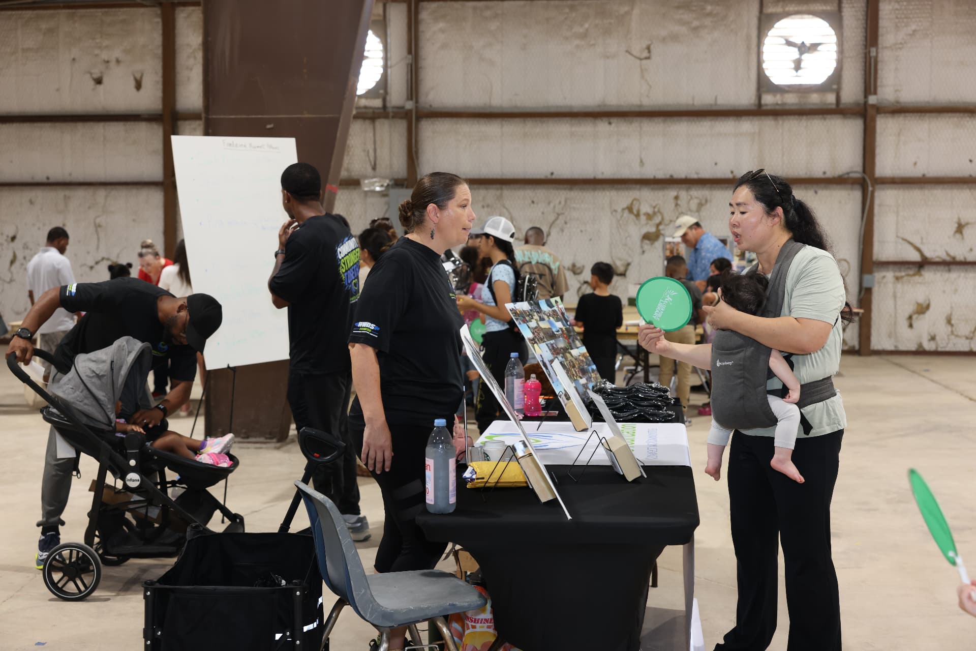 Attendees talking with the HWDS Foundation team at their resource table.