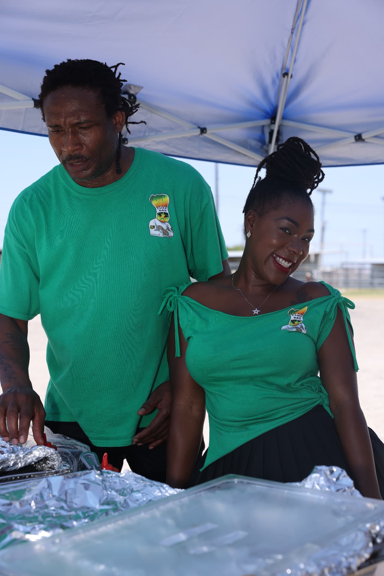 Chef Ras and his partner preparing plates at the food vendor tent.