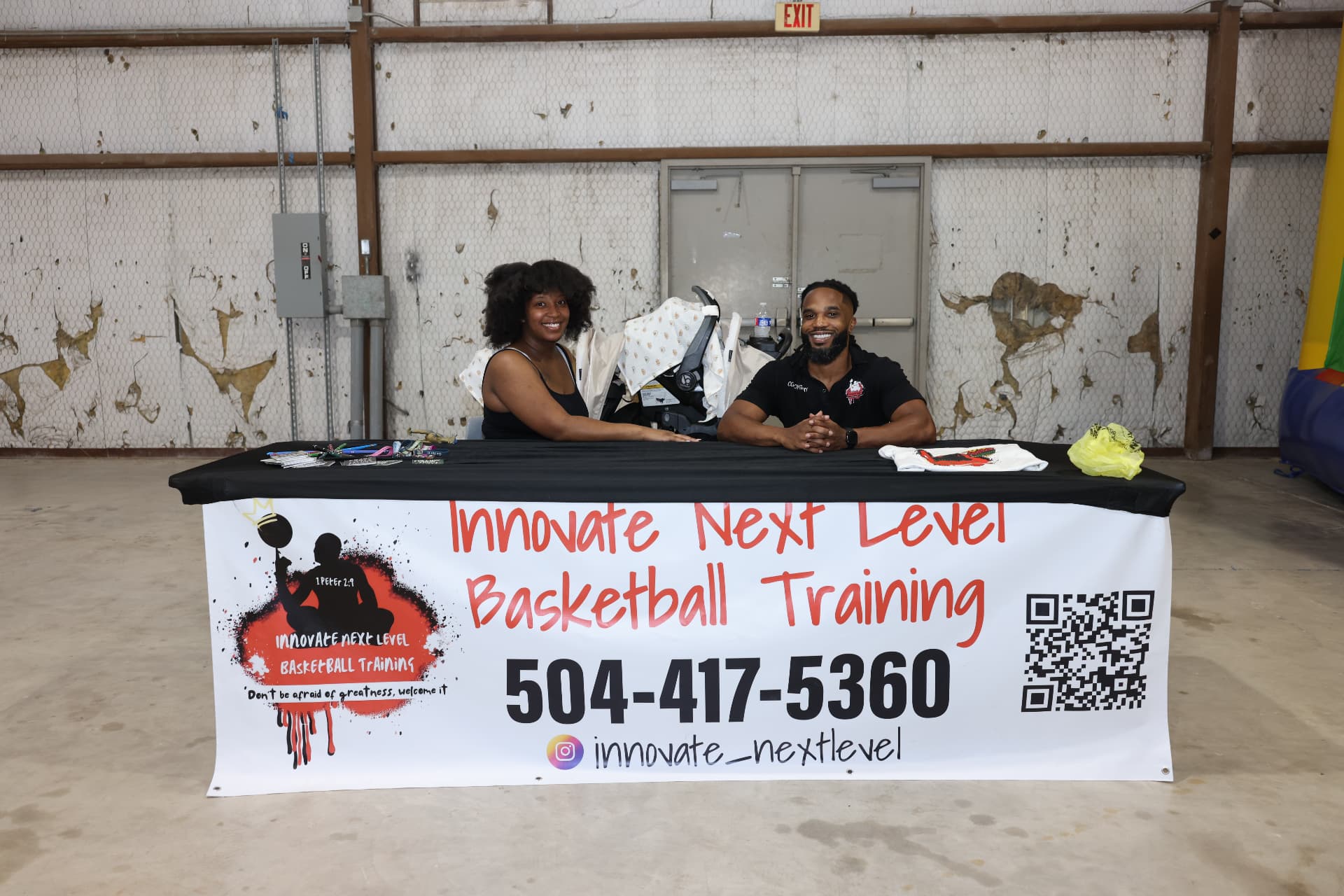 Innovate Next Level Basketball Training team seated at their banner table.