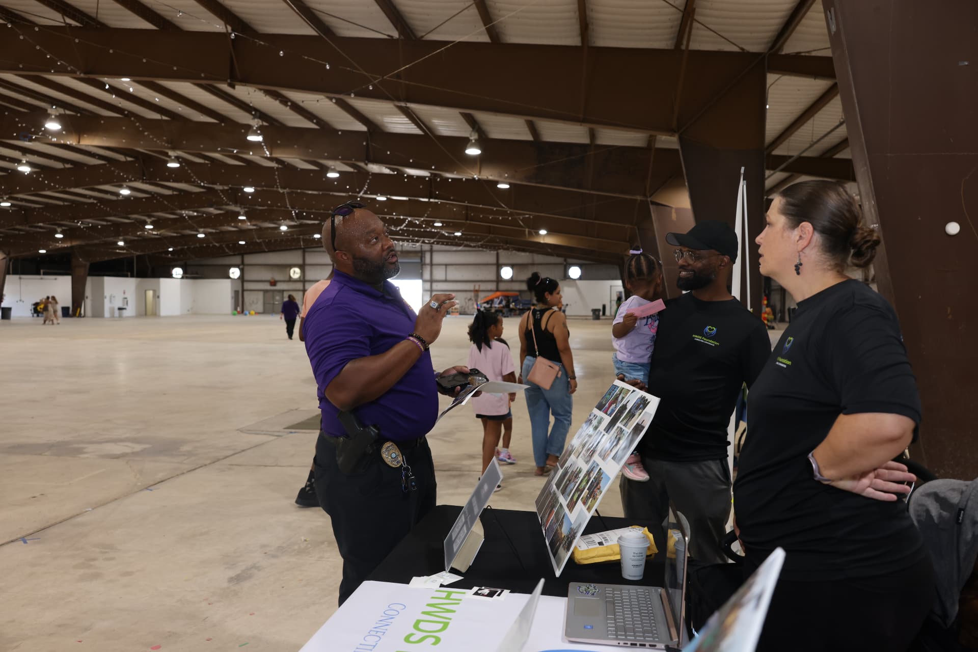 A Killeen Police officer talking with the HWDS Foundation team at their booth.