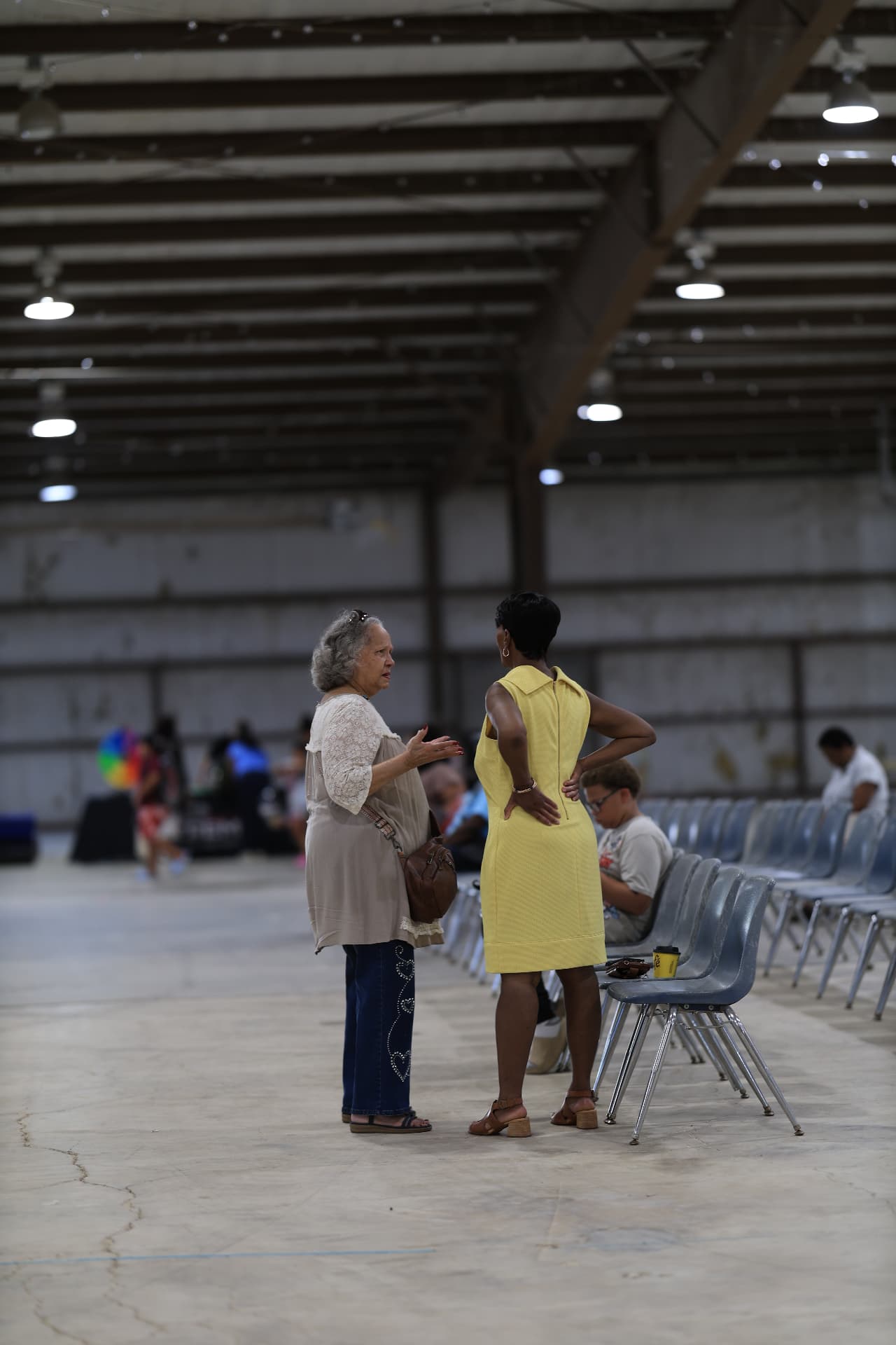Two attendees talking together inside the venue during the festival.
