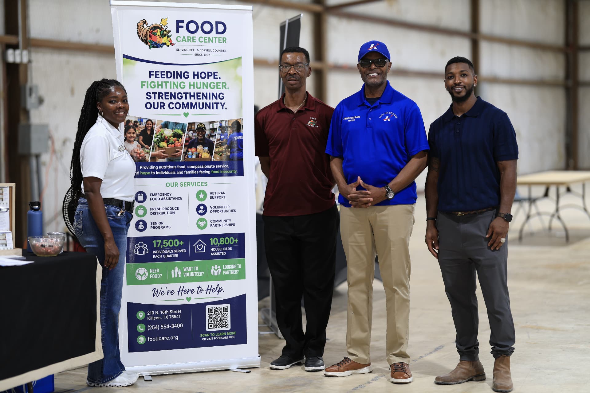 Food Care Center team with Mayor Joseph Solomon and festival organizers at their banner.