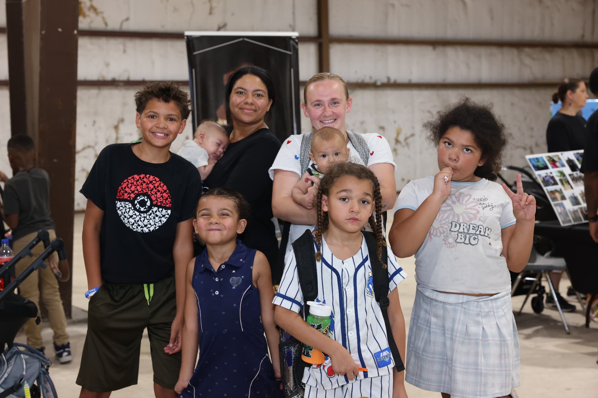 A large group of children and moms posing together at the festival.