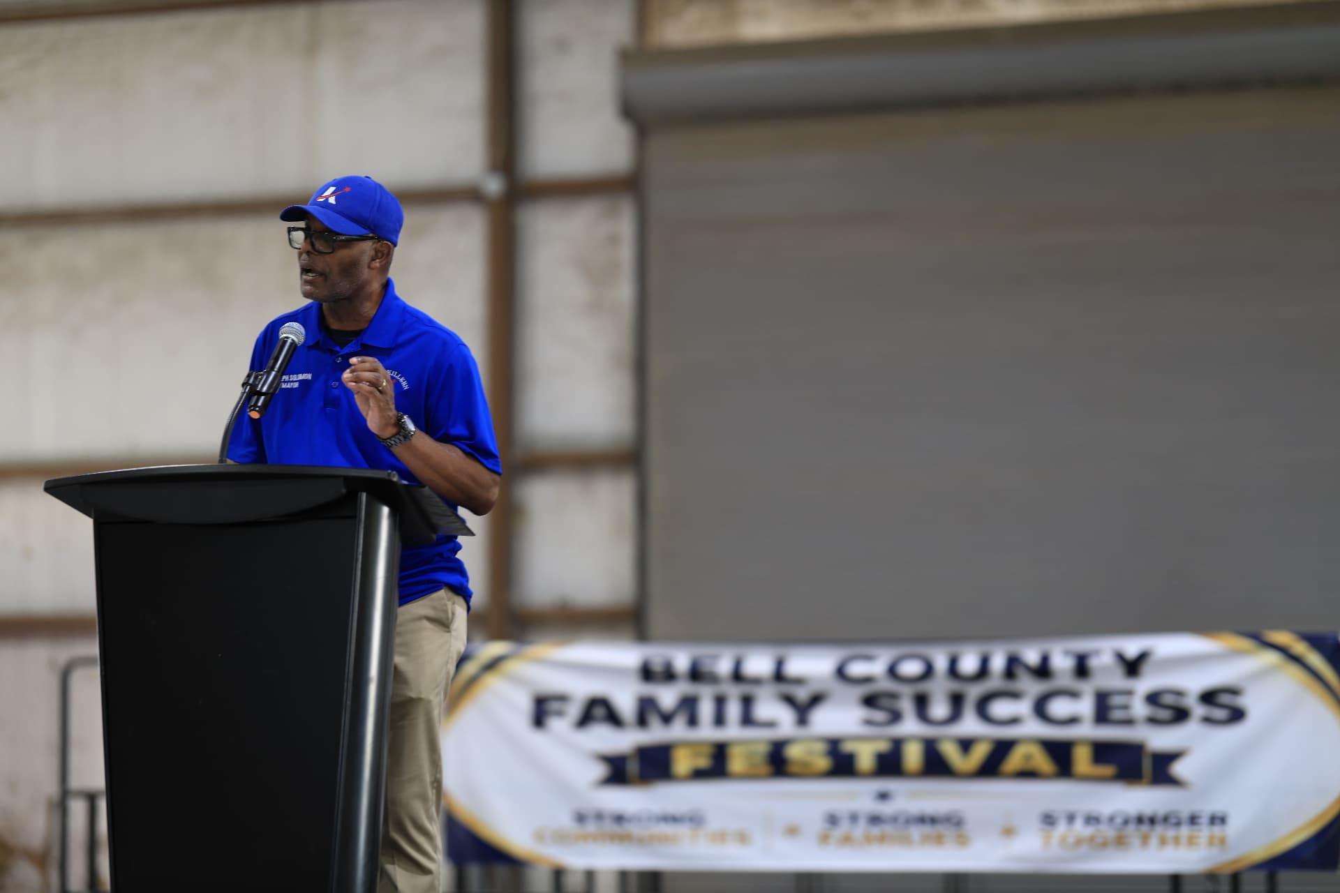 Mayor Joseph Solomon speaking in front of the Bell County Family Success Festival banner.