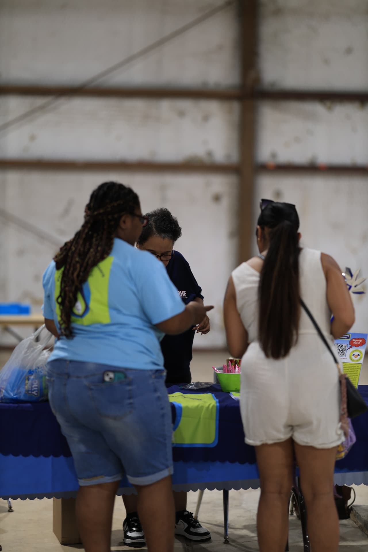 Attendees signing up at a community partner table.