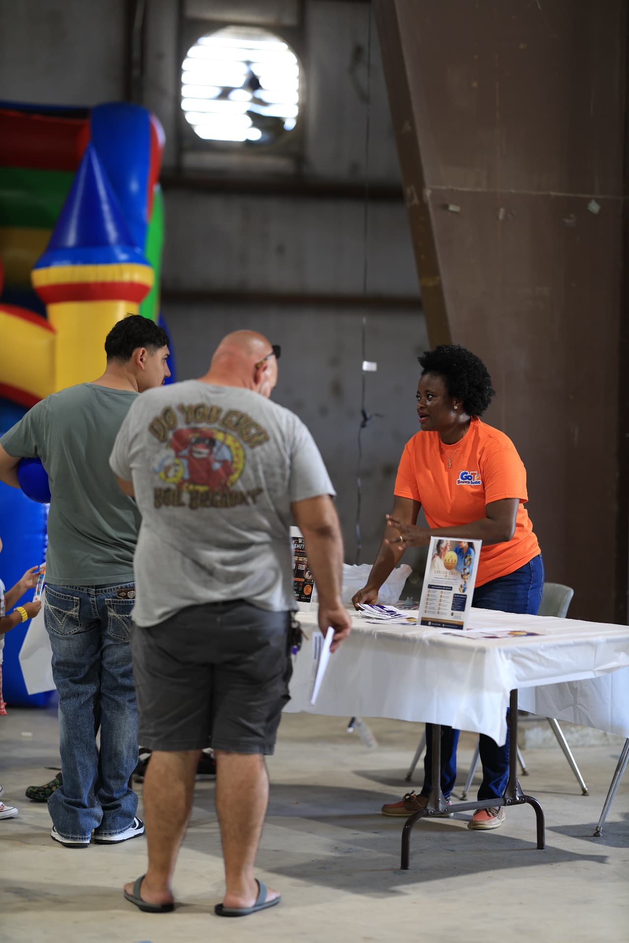A GoTi Bounce House representative sharing information with attendees.
