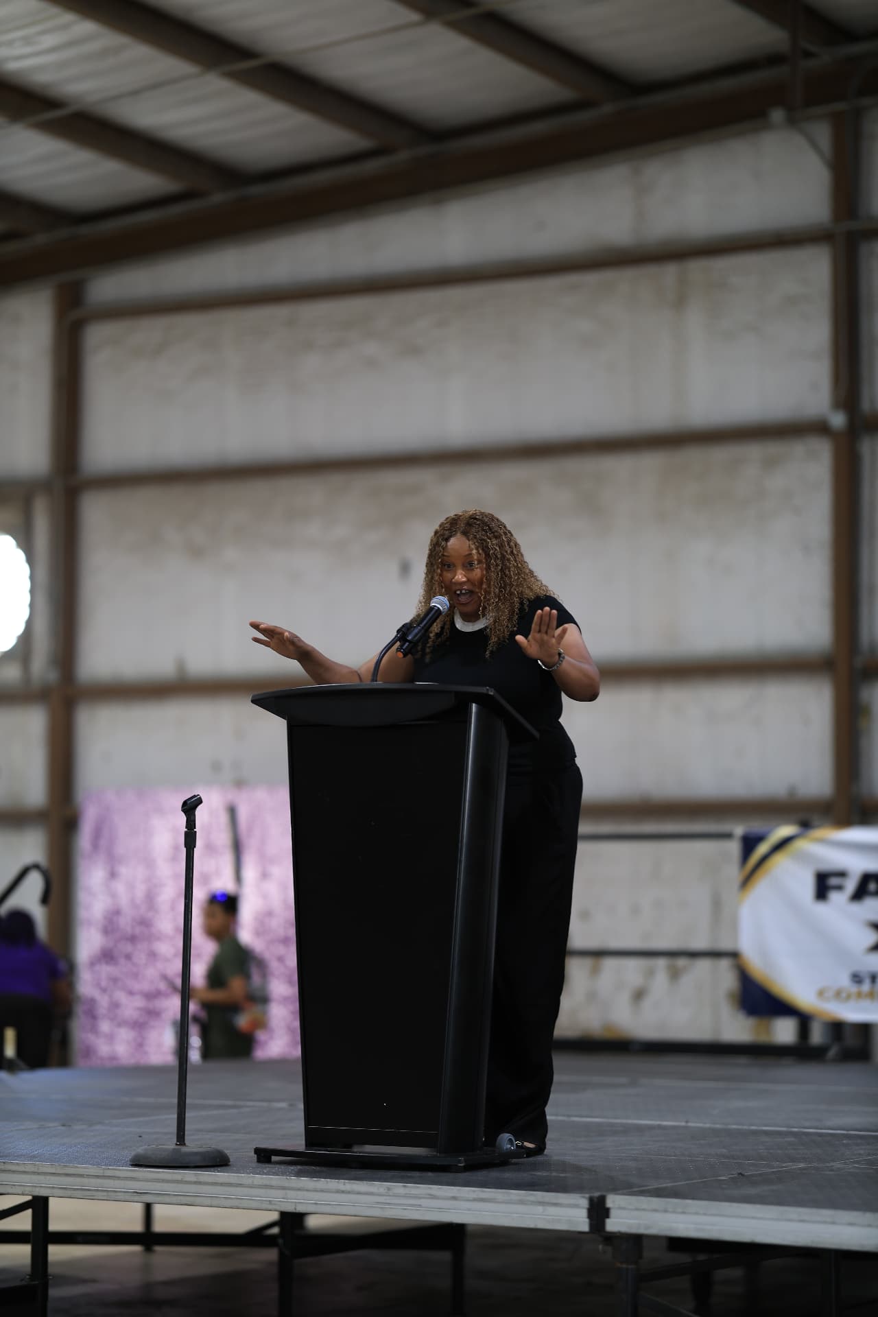 A speaker energetically addressing families from the stage.