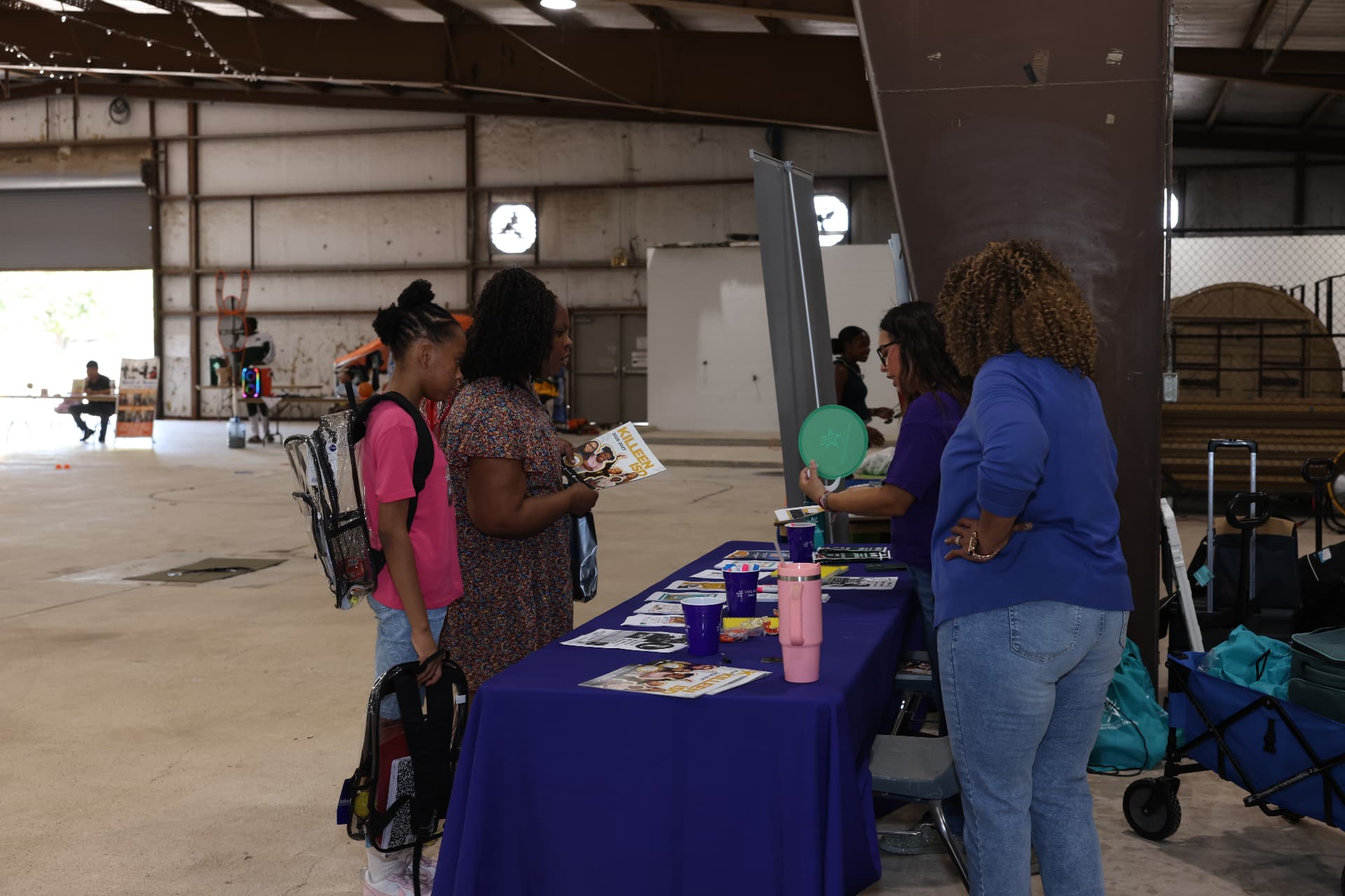A mother and daughter picking up Killeen ISD information at a partner table.