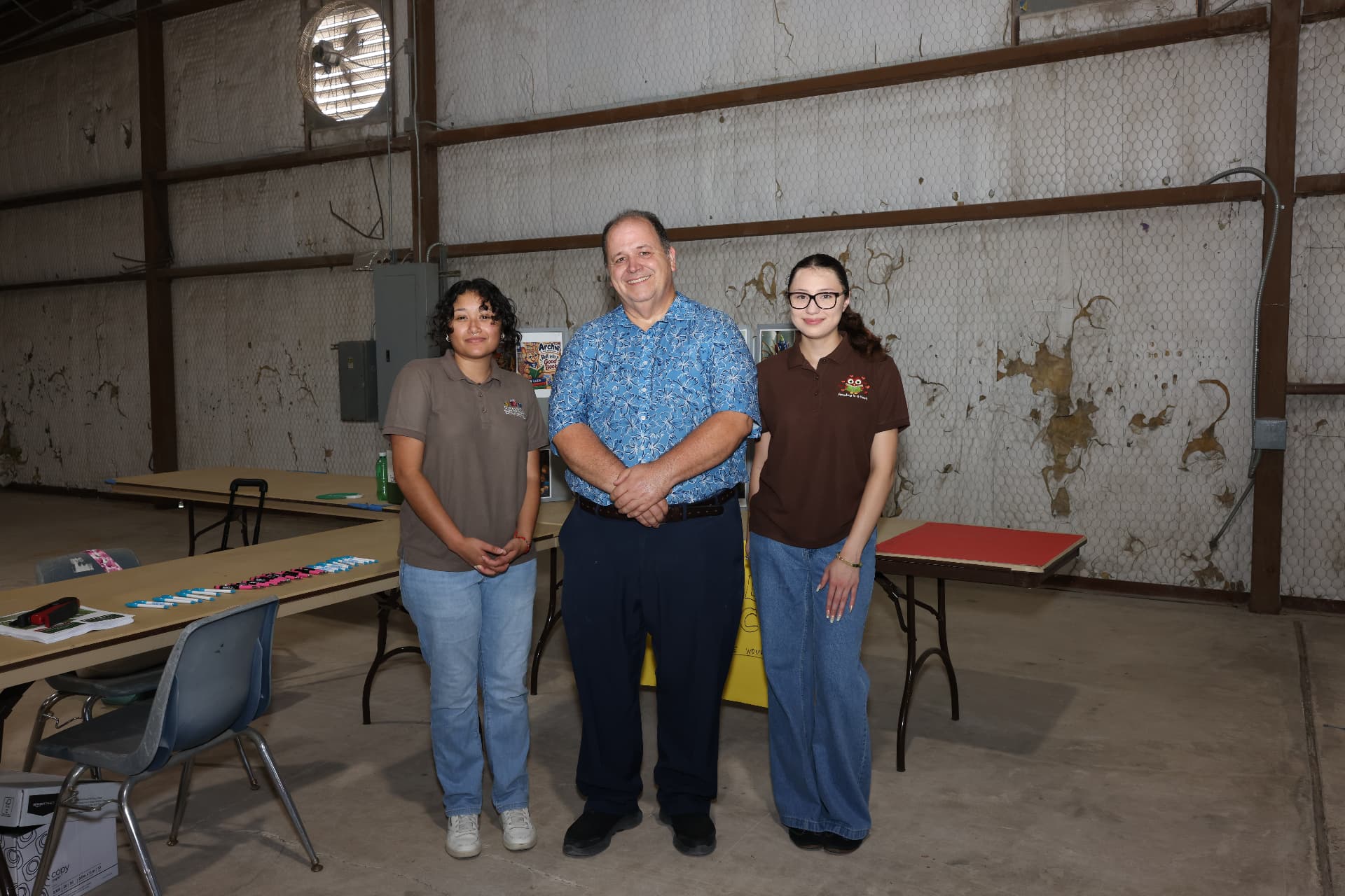 Central Texas Children's Academy staff with a community leader at their booth.