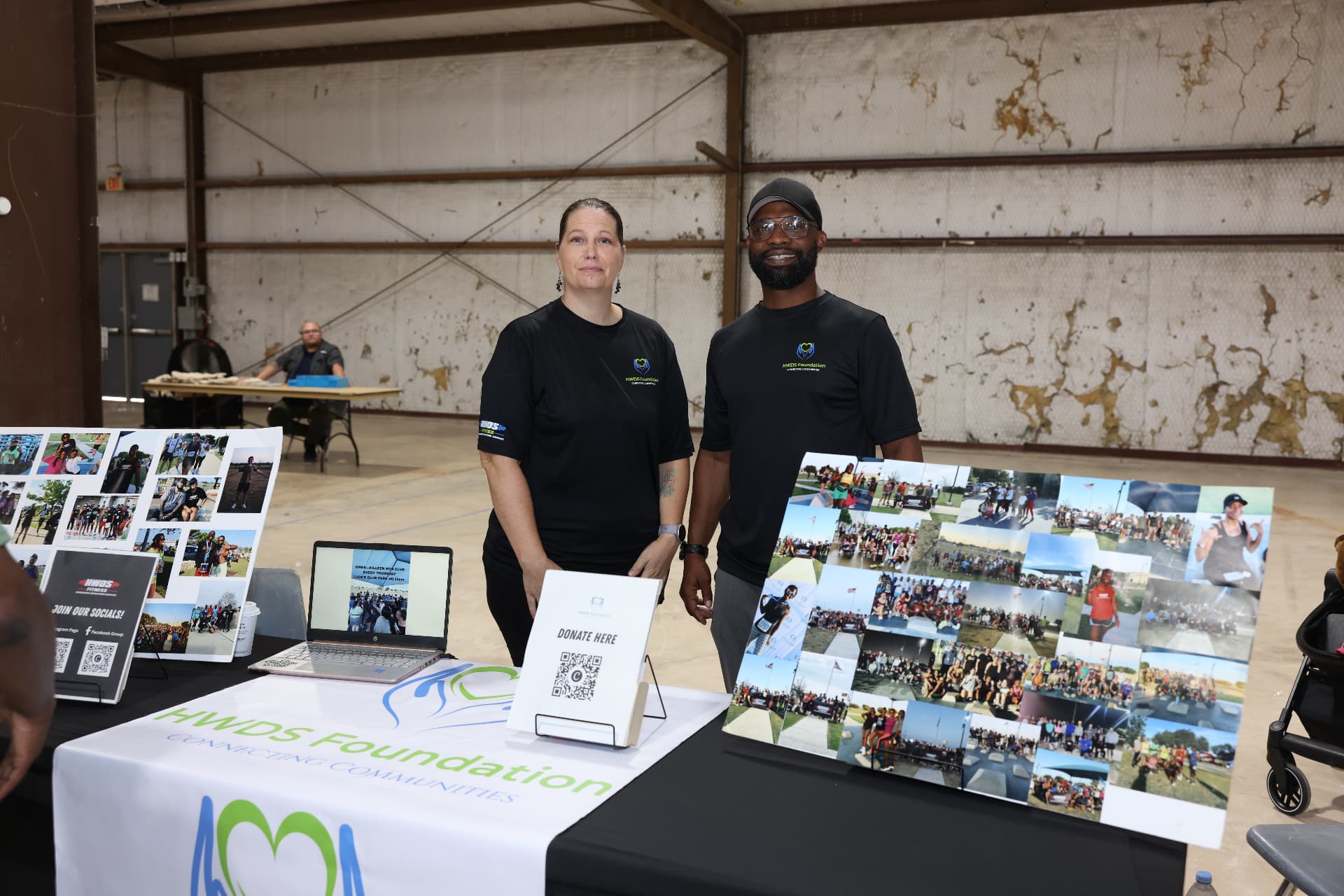 HWDS Foundation team members standing at their community fitness booth.