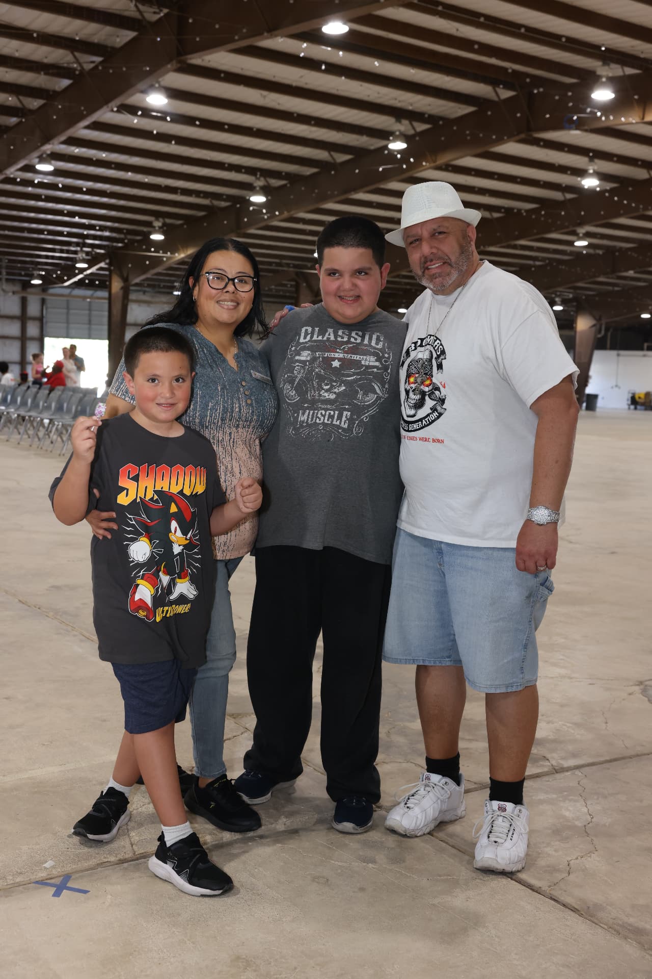 A family of four smiling together inside the venue.