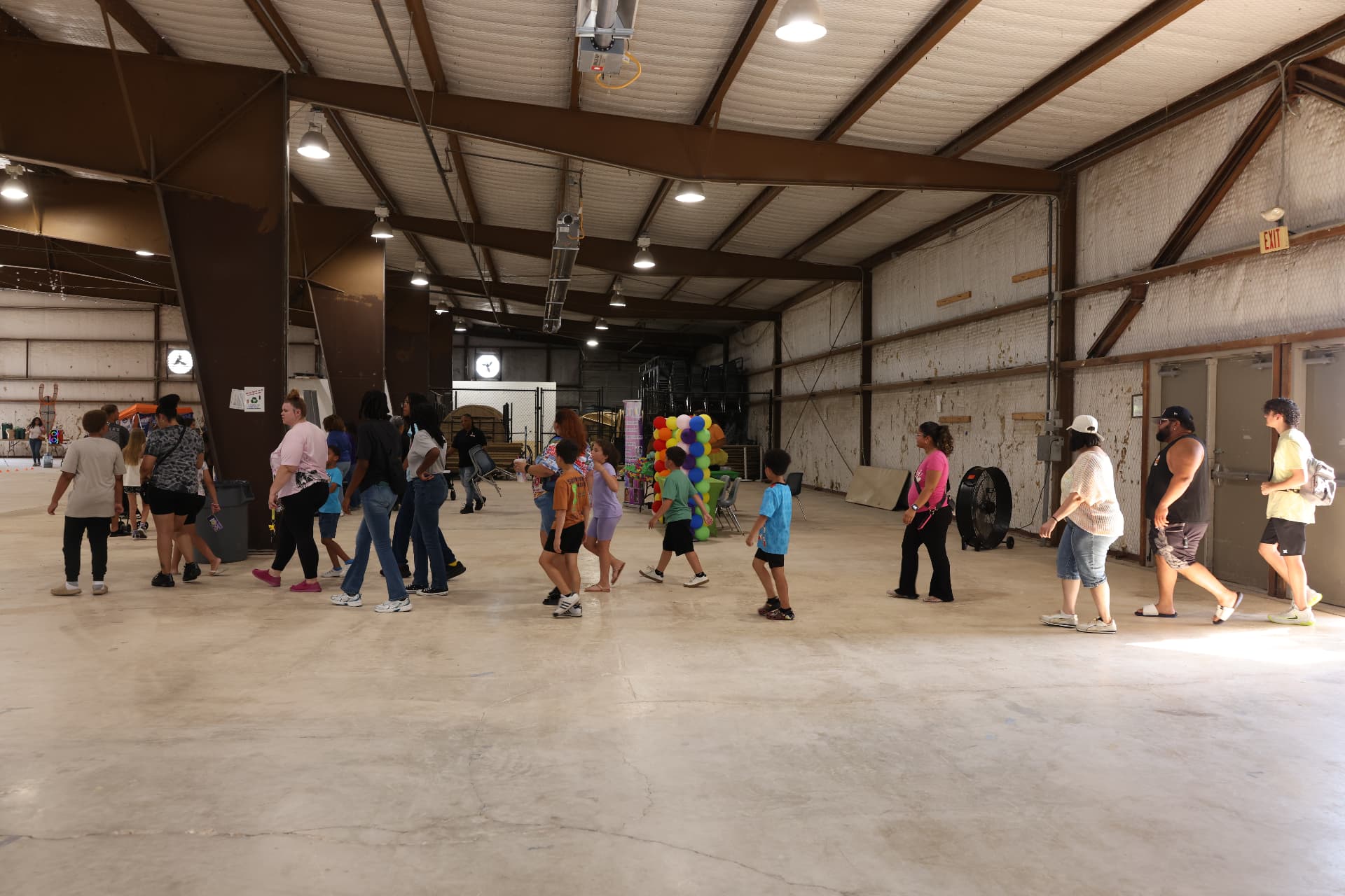 Families walking through the venue toward the activity area.