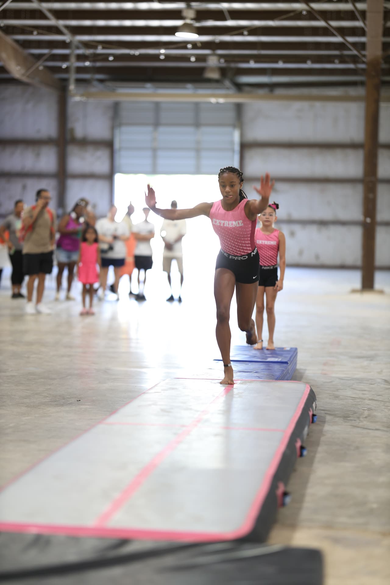 An Extreme gymnast tumbling down the air track during the performance.