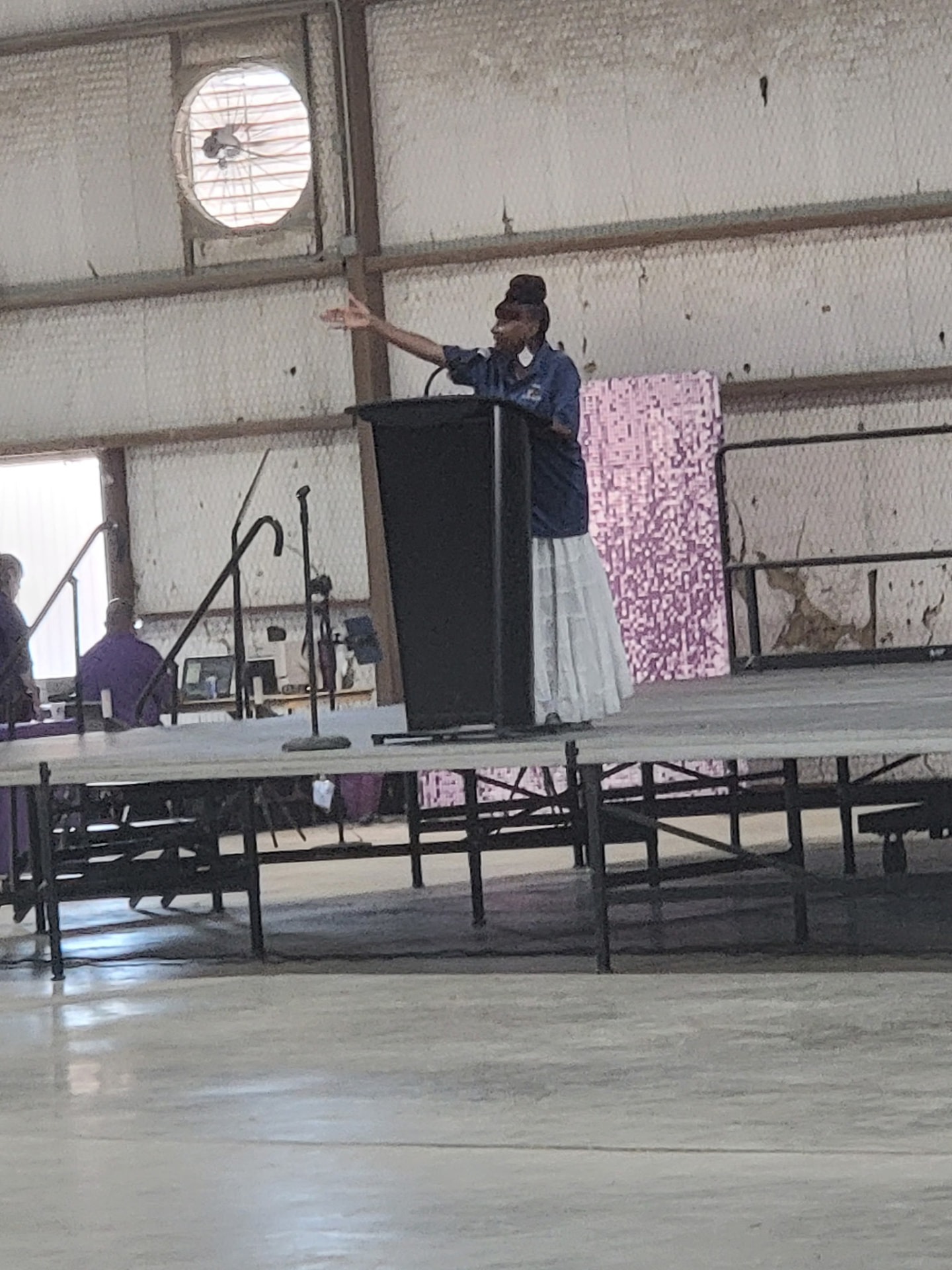 A community speaker addressing families from the stage podium.
