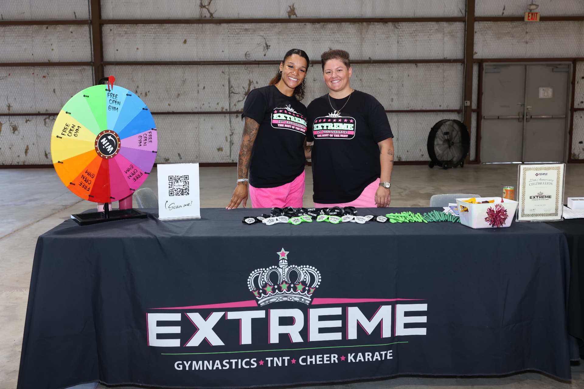 Extreme Gymnastics and Cheer staff at their prize wheel booth.