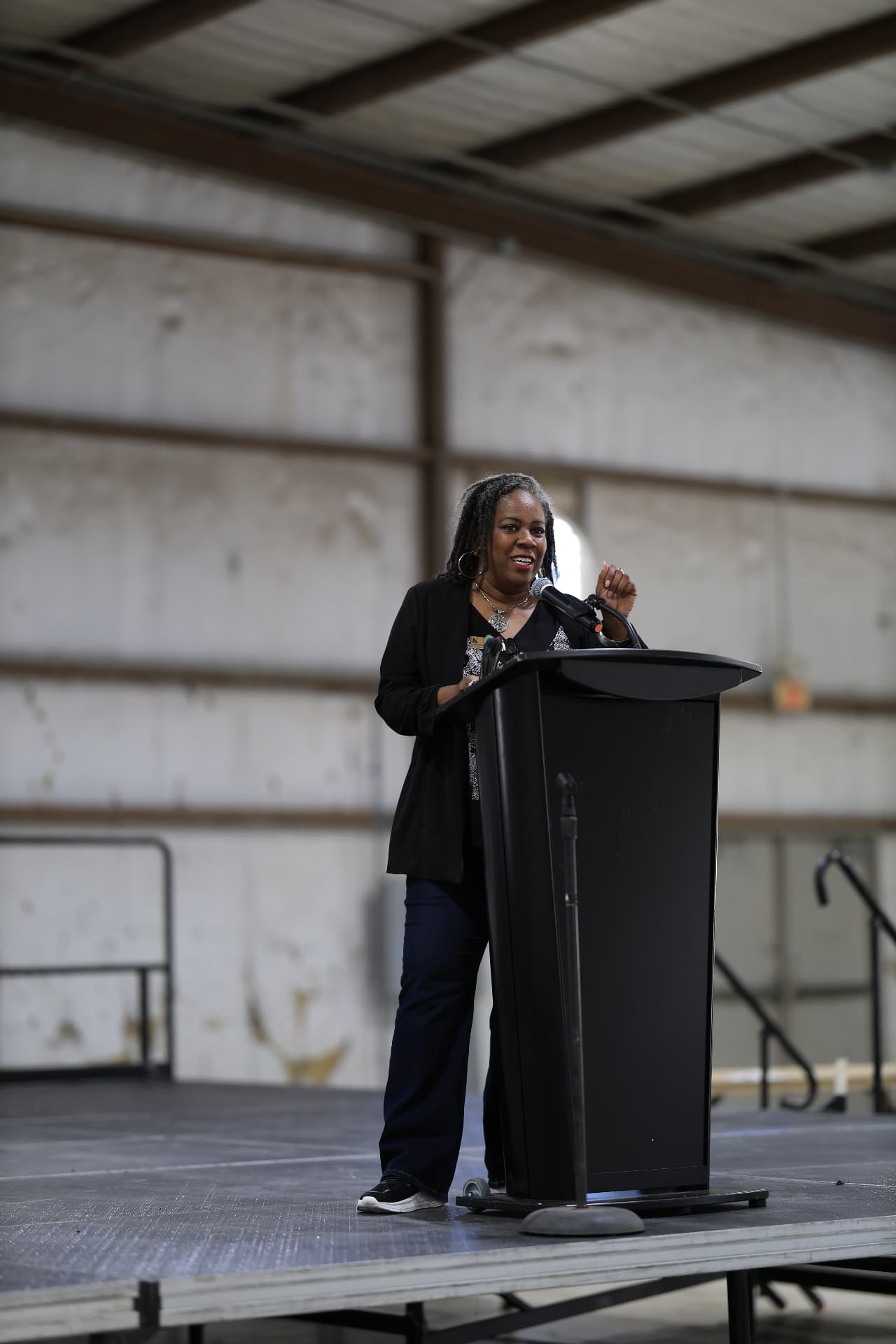 A council member smiling while addressing the festival crowd.