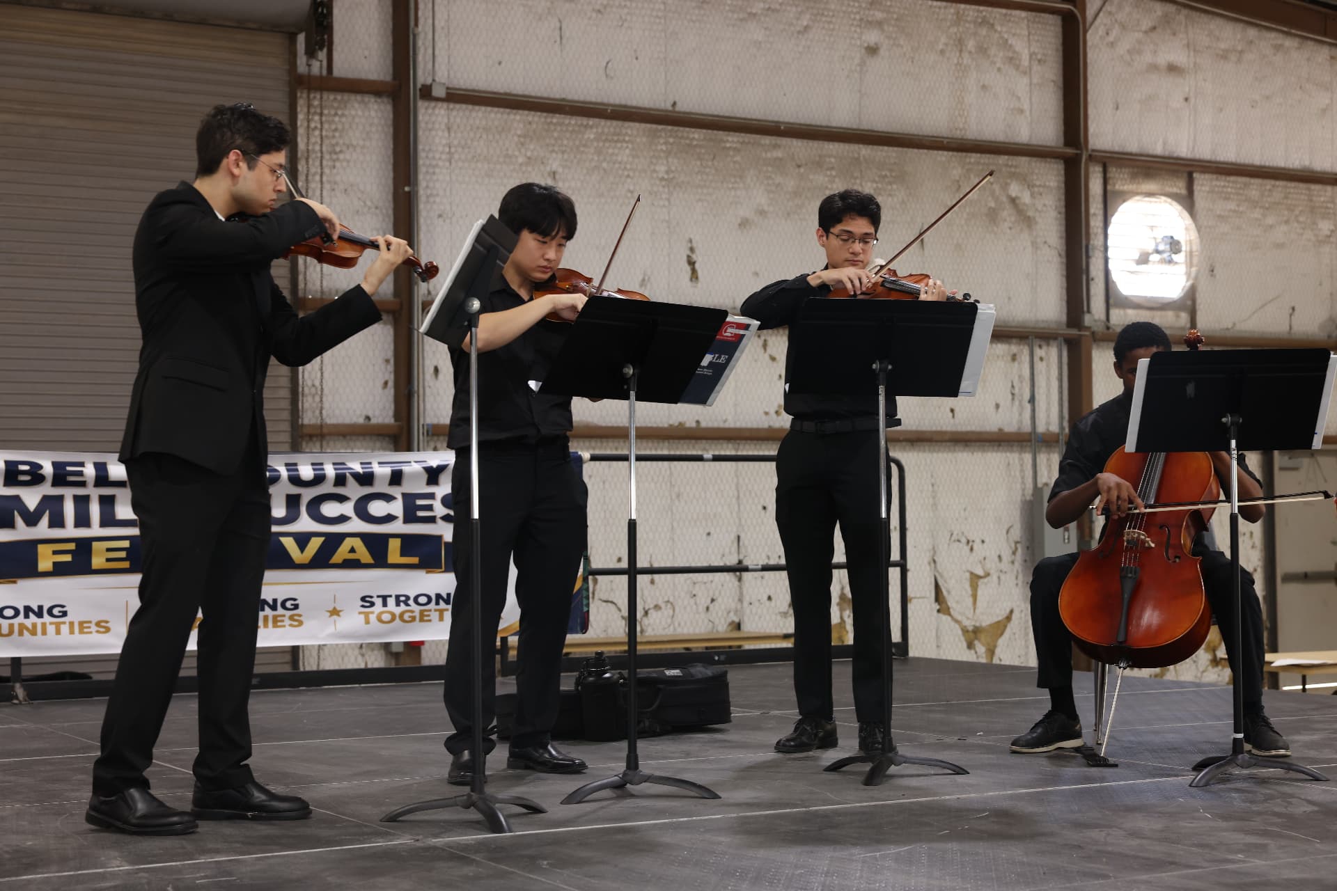 A student string quartet performing on stage at the festival.