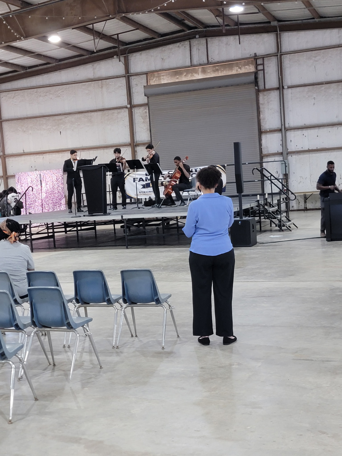 A student string quartet performing on the community stage.