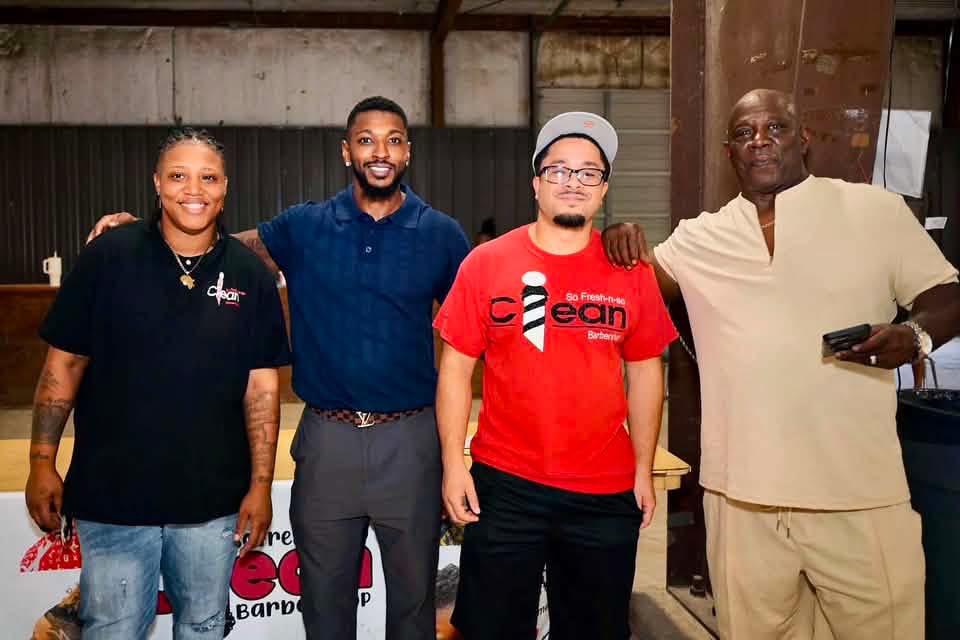 So Fresh-N-So Clean Barbershop team with the festival organizer at their partner booth.